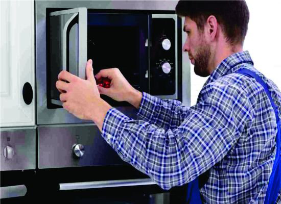 Microwave repair technician working
